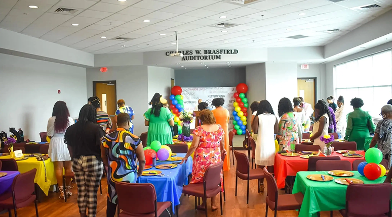 Colorful event in auditorium with balloons
